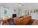 Bright living room with marble fireplace, ceiling fan, and views to the entryway and adjacent rooms at 4408 Queenstown Ct, Raleigh, NC 27612