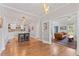 Open-concept living space features hardwood floors, a kitchen island, and a cozy living room area at 4408 Queenstown Ct, Raleigh, NC 27612