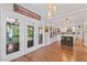 Open-concept living space features hardwood floors, a kitchen island, and access to the outdoor space at 4408 Queenstown Ct, Raleigh, NC 27612