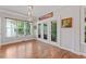 Bright and airy living space features large windows, hardwood floors and access to outdoor spaces at 4408 Queenstown Ct, Raleigh, NC 27612