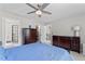 Main bedroom with ceiling fan, walk-in closet, and bath with glass shower at 4408 Queenstown Ct, Raleigh, NC 27612