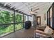 Relaxing screened-in porch with ceiling fan, grill, and comfortable seating area at 4408 Queenstown Ct, Raleigh, NC 27612