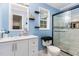 Bright bathroom features a modern white vanity, framed mirror, and updated glass enclosed shower with tiled walls at 4575 Wendell Blvd, Wendell, NC 27591