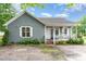 Charming single-story home featuring gray wood shingles, white trim, and a welcoming front porch with a small yard at 4575 Wendell Blvd, Wendell, NC 27591
