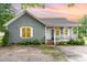 Charming single-story home featuring gray wood shingles, white trim, and a welcoming front porch with a small yard at 4575 Wendell Blvd, Wendell, NC 27591