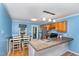 Bright kitchen and dining area with stainless steel appliances, wood cabinets, and breakfast bar seating at 4575 Wendell Blvd, Wendell, NC 27591