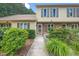 Inviting townhome featuring a landscaped front yard and neutral siding with decorative shutters at 46 Sparger Springs Ln, Durham, NC 27705