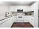 Stylish kitchen with white cabinetry, modern appliances, and granite countertops at 46 Sparger Springs Ln, Durham, NC 27705