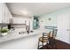 Bright kitchen featuring white cabinets, stainless steel sink, granite countertops, and breakfast bar at 46 Sparger Springs Ln, Durham, NC 27705