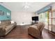 Bright living room featuring hardwood floors, comfortable seating and natural light from the window at 46 Sparger Springs Ln, Durham, NC 27705