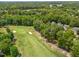 Aerial view showcasing the golf course adjacent to homes with lush landscaping at 4705 Royal Troon Dr, Raleigh, NC 27604