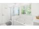 Bright bathroom with a large soaking tub and separate glass-enclosed shower for a spa-like feel at 4705 Royal Troon Dr, Raleigh, NC 27604