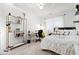 Bright bedroom with decorative shelving, a workspace, and a comfortable bed with floral bedding at 4705 Royal Troon Dr, Raleigh, NC 27604