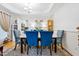 Formal dining room with elegant blue chairs, a modern chandelier, and tasteful decor at 4705 Royal Troon Dr, Raleigh, NC 27604