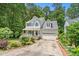 Well-maintained two-story home with a welcoming front porch and lush landscaping at 4705 Royal Troon Dr, Raleigh, NC 27604