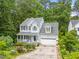 Charming two-story home featuring a front porch, attached garage, and mature trees at 4705 Royal Troon Dr, Raleigh, NC 27604