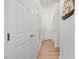 Hallway featuring wood flooring, closet space, and a decorative ship hanging on the wall at 4705 Royal Troon Dr, Raleigh, NC 27604