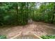 View of the wooded lot from top of deck stairs shows backyard shed at 4710 Rollingwood Dr, Durham, NC 27713