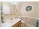 Bathroom with a wood vanity, patterned floors, and octagon window at 4710 Rollingwood Dr, Durham, NC 27713