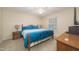 Bedroom with a metal frame bed, matching bedside lamps, and a neutral colored carpet at 4710 Rollingwood Dr, Durham, NC 27713