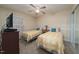 Inviting bedroom featuring two twin beds with yellow bedding, a dresser, and cozy decor at 4710 Rollingwood Dr, Durham, NC 27713