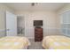 Shared bedroom features two twin beds with yellow quilts and a central nightstand between them at 4710 Rollingwood Dr, Durham, NC 27713