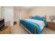 Comfortable bedroom featuring a queen bed with blue bedding, and a well-lit bedside table at 4710 Rollingwood Dr, Durham, NC 27713