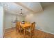 Cozy dining room with hardwood floors, decorative light fixture, and large window at 4710 Rollingwood Dr, Durham, NC 27713