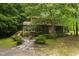 Two-story house with stone pathway, landscaped yard, and lush, mature trees at 4710 Rollingwood Dr, Durham, NC 27713