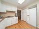 A kitchen featuring white cabinets and appliances, hardwood floors, and recessed lighting at 4710 Rollingwood Dr, Durham, NC 27713