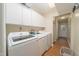 Laundry room with white cabinets, counter space, and new washer and dryer units at 4710 Rollingwood Dr, Durham, NC 27713
