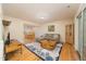 Cozy living room with hardwood floors, comfortable seating, and open dining area at 4710 Rollingwood Dr, Durham, NC 27713