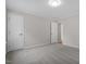 Neutral bedroom with gray carpet, white doors, and trim, showcasing the clean and simple design of the space at 4720 Brigadoon Dr, Durham, NC 27705