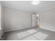 Neutral bedroom with gray carpet, light gray walls, white trim, and ample natural light, creating a cozy and inviting space at 4720 Brigadoon Dr, Durham, NC 27705