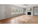 Sun-filled living room with a fireplace, hardwood floors, and natural light at 4720 Brigadoon Dr, Durham, NC 27705