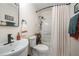 Simple bathroom with a shower and classic white fixtures, complemented by a decorative towel and rug at 4777 Helena Moriah Rd, Rougemont, NC 27572