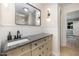 Bathroom with decorative wall paneling, granite countertop, stylish lighting, and mirror at 4777 Helena Moriah Rd, Rougemont, NC 27572