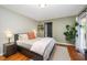 Bright bedroom with hardwood floors, a queen bed, and a sliding glass door to the outdoors at 4777 Helena Moriah Rd, Rougemont, NC 27572