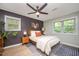 Comfortable bedroom with natural light, a ceiling fan, and a striped area rug at 4777 Helena Moriah Rd, Rougemont, NC 27572
