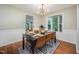 Elegant dining room featuring stylish decor, large windows, and hardwood floors at 4777 Helena Moriah Rd, Rougemont, NC 27572