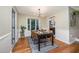 Stylish dining room with modern light fixture and adjacent view into kitchen and living area at 4777 Helena Moriah Rd, Rougemont, NC 27572