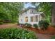 Exterior view of the house featuring a sunroom, landscaping, and a glimpse of the backyard at 4777 Helena Moriah Rd, Rougemont, NC 27572