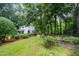 Two-story home with lush greenery, surrounded by mature trees and offering a serene, private setting at 4777 Helena Moriah Rd, Rougemont, NC 27572