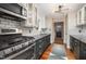 View of the kitchen with stainless steel appliances, subway tile backsplash, and granite countertops at 4777 Helena Moriah Rd, Rougemont, NC 27572