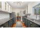 Well-lit kitchen with black countertops, subway tile, stainless steel appliances, and modern lighting fixture at 4777 Helena Moriah Rd, Rougemont, NC 27572