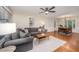 Open-concept living room flowing into dining area, featuring hardwood floors and bright lighting at 4777 Helena Moriah Rd, Rougemont, NC 27572