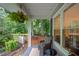 Relaxing screened porch with comfortable seating and view of the serene, wooded backyard at 4777 Helena Moriah Rd, Rougemont, NC 27572