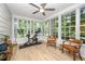 Bright sunroom with large windows, exercise equipment, and comfortable seating at 4777 Helena Moriah Rd, Rougemont, NC 27572