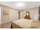 Serene bedroom with neutral decor, carpeted floors, and ample closet space for storage at 506 E E St, Butner, NC 27509