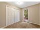 Comfortable bedroom featuring carpet, a window overlooking greenery, and a large closet with sliding doors at 506 E E St, Butner, NC 27509